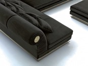 Угловой черный диван с круглыми серебристыми накладками