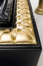 Черный кожаный диван с золотистым декором